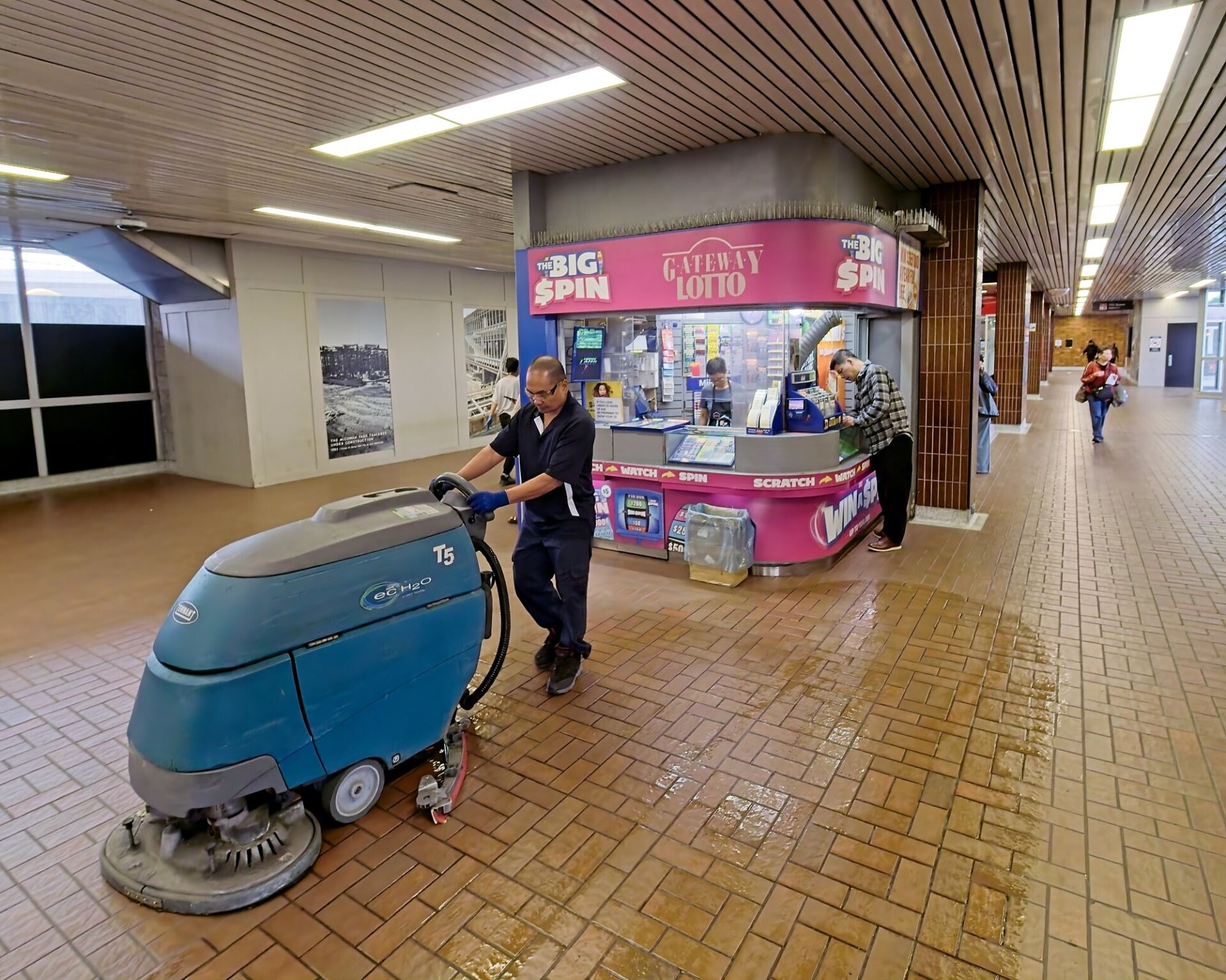 Floor polisher in front of lottery ticket kiosk