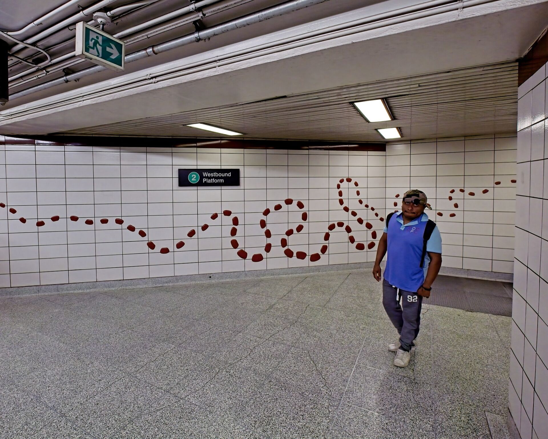 Station interior with path/breadcrumb motif on the wall